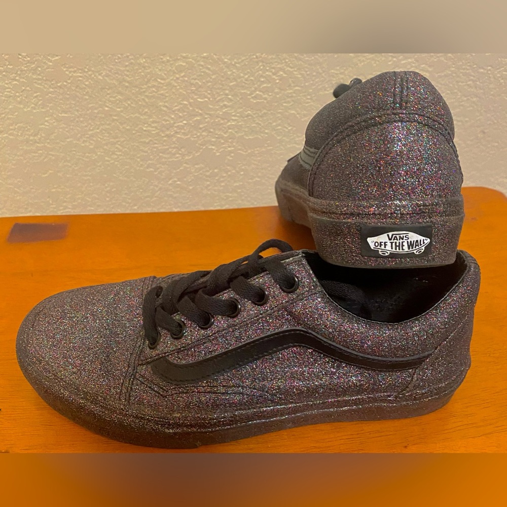 A limited edition Vans. All black covered in multi colored GLITTER print